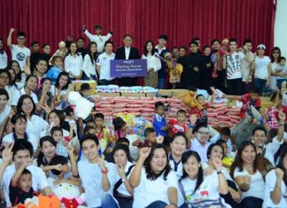 Fr. Michael Weera Phangrak (center), executive director of the orphanage, accepts donations from Piya Rattanaburee, manager of customers relations, and Sukhrudee Pongpanwattana, director of creative and corporation communications, with the committee from King Power Co. Ltd., and the performers, care givers and children.